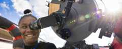 Student looking through telescope
