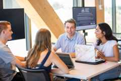 4 students sitting at a table