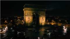 Cars driving around a monument.