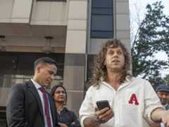 Jamie Marsicano speaks at a press conference, with her attorney Xavier T. de Janon standing behind her, outside the Fulton County Courthouse, following a motions hearing the 'Cop City' racketeering case on Sept. 8, 2025.