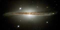 Edge-on view of a gracefully flat S shaped galaxy with prominent dust clouds.