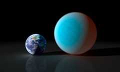 Smaller Earth next to blue planet over twice Earth's diameter.