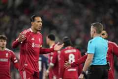Liverpool's Virgil van Dijk, centre left, reacts during the Champions League opening phase soccer match between Liverpool and PSV in Liverpool, England, Wednesday, Nov. 26, 2025. (AP Photo/Jon Super)