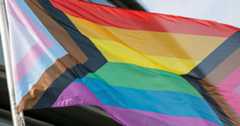 Trans Inclusive flag billowing to illustrate a piece about the Coalition against transphobia
