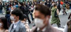 People wear protective masks in Tokyo, Japan. People wear protective masks in Tokyo, Japan.