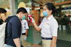 Staff check customers’ temperatures at a shopping mall entrance in Yangon, Myanmar. Staff check customers’ temperatures at a shopping mall entrance in Yangon, Myanmar.