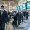 Commuters wear protective masks in Shinagawa, Tokyo. Commuters wear protective masks in Shinagawa, Tokyo.
