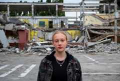 A twelve-year-old girl stands in front of her school which was destroyed in an air strike during the conflict in Kharkiv, Ukraine. A twelve-year-old girl stands in front of her school which was destroyed in an air strike during the conflict in Kharkiv, Ukraine.