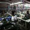 Young factory workers producing shirts in Accra, Ghana. Young factory workers producing shirts in Accra, Ghana.