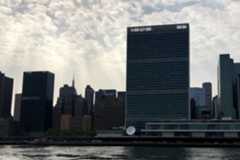 UN Headquarters against sun rays beaming from cloudy skies UN Headquarters against sun rays beaming from cloudy skies
