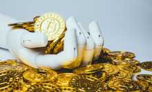 Robotic hand holding bitcoin - stock photo