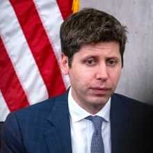 Sam Altman looks despondent in front of an American flag