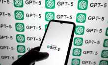 The OpenAI GPT-5 logo appears on a smartphone screen and as a background on a laptop screen in this photo illustration in Athens, Greece, on August 7, 2025.