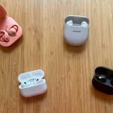 four pairs of earbuds on a table