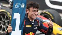 Arvid Lindblad holds up a number one sign after winnng an F2 race