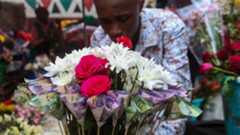 A Kenyan businessman prepares a money bouquet made up of Kenya shillings mixed with fresh flowers for a customer during Valentine's day