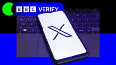 A mobile phone with the 'X' logo next to a laptop keyboard