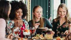 Group of female friends eating in a restaurant