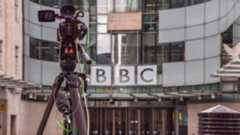The front of the BBC's New Broadcasting House - a television camera can be seen, on a tripod