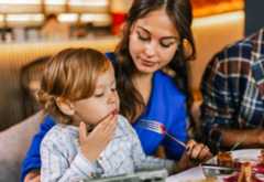 Woman in restaurant with young child
