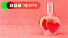 A treated image of a glass beaker with two hearts inside