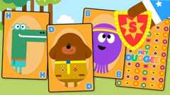 Cards with duggee and betty on. There is a hand with a snap badge.