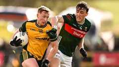 Oisín Gallen of Donegal in action against Donnacha McHugh