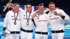 Great Britain's Duncan Scott, James Guy, Matthew Richards and Tom Dean pose with their gold medals