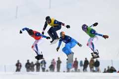 Snowboarders jump in unison