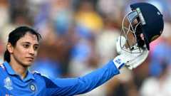India's Smriti Mandhana celebrates after scoring a century (100 runs) during the ICC Women's Cricket World Cup 2025 one-day international (ODI) match between India and New Zealand at the DY Patil Stadium in Navi Mumbai on October 23, 2025