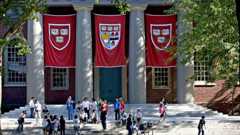 Students gather on the steps of Memorial Church inside Harvard University's campus in Cambridge, Massachusetts