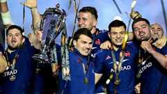 France's Antoine Dupont lifts the 2025 Six Nations trophy surrounded by team-mates