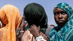 Women who have fled Darfur queue to register themselves at a camp in Chad, in October 2025.