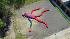 Aerial view of the sock monkey lying on concrete