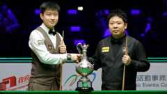 Zhao Xintong shakes the hand of Zhang Anda before the start of Sunday's World Grand Prix final in Hong Hong