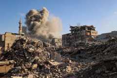 Smoke billows from a building in the Bureij camp for Palestinian refugees in Gaza after Israeli strikes