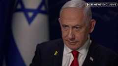 Benjamin Netanyahu is doing an interview with CBS News with an Israeli flag in the back.