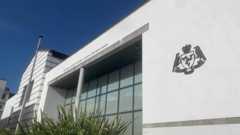 The exterior of Douglas Courthouse, a grand white building with large windows on a clear day.