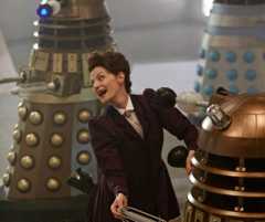 Michelle Gomez as Missy dancing with some daleks