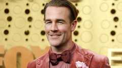 James Van Der Beek wearing a maroon dickie bow while smiling for the cameras on arrival at the 2019 Emmy Awards