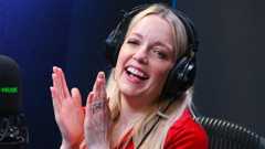 Lauren Laverne in a radio studios wearing headphones, laughing with her head tilted back and her hands raised in a clapping motion