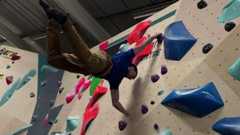 Paraclimber Sebastian Musson scales up a wall, flicking his legs out to be near horizontal