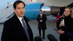 US Secretary of State Mark Rubio in black coat with suit and tie talks to reporters
