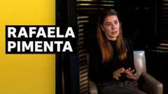 Football agent Rafaela Pimenta sitting in a chair mid interview