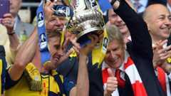 Arsene Wenger and Nacho Monreal celebrate with the FA Cup trophy