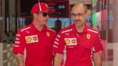 Kimi Raikkonen and Carlo Santi walk through the Ferrari garage