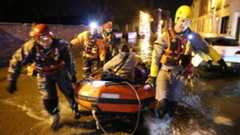 Rescuers taking people to safety in a boat in Boston, Lincs