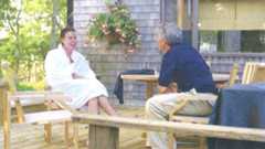 Peter Mandelson, sitting opposite Jeffrey Epstein, wearing a white robe