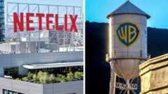 On the left, a large red NETFLIX sign sits on top of a building. On the right is the iconic Warner Bros water tower with the gold and blue shield logo of the company.