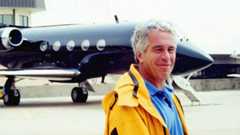 Jeffrey Epstein standing in front of his private plane